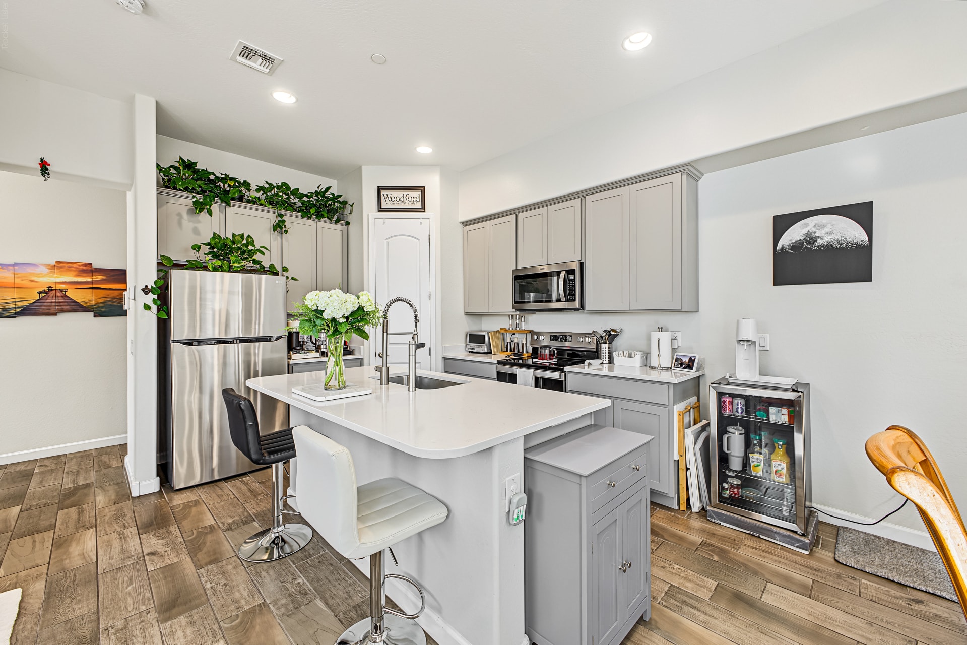 Interior — kitchen with quartz island and SS appliances