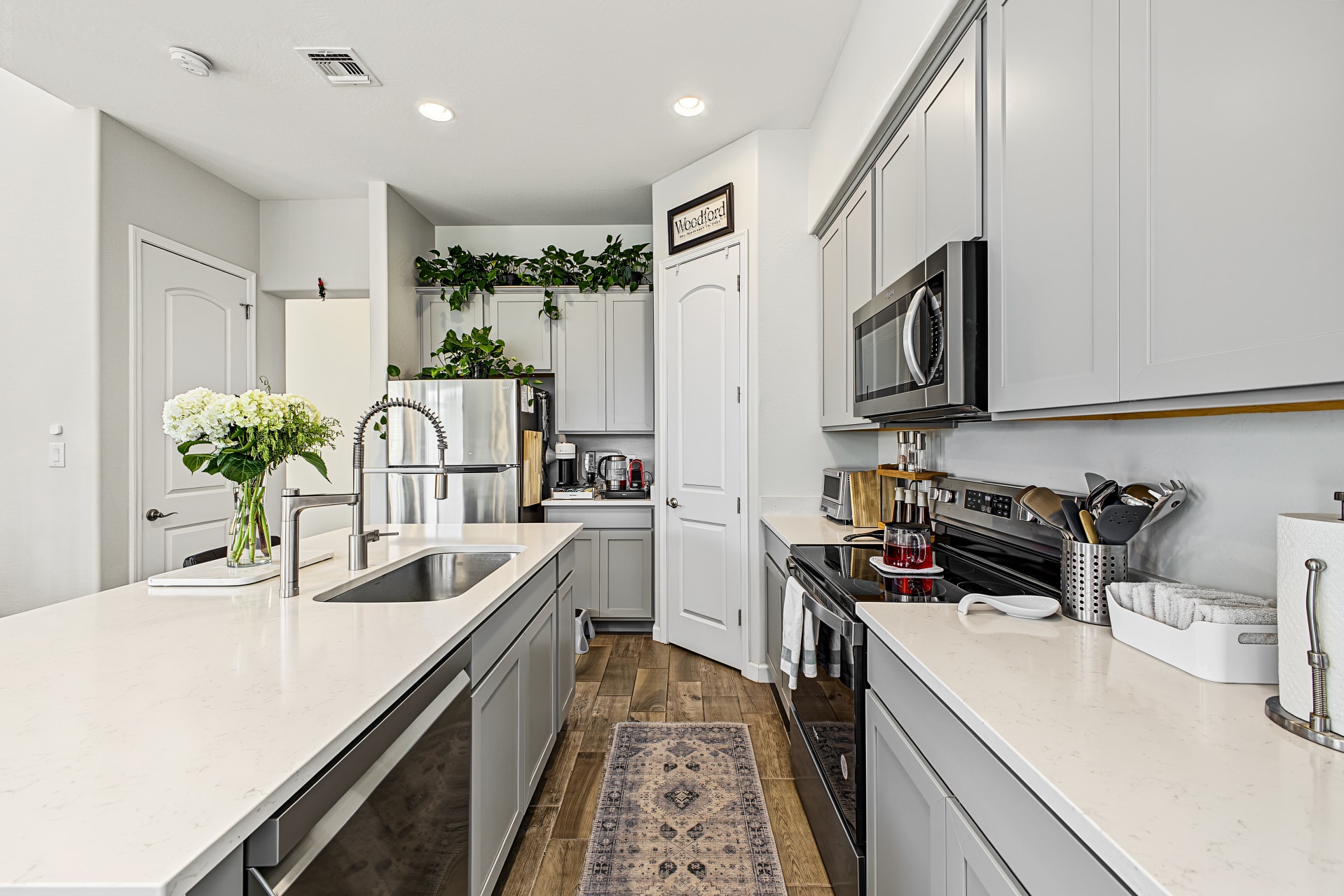 Interior — full kitchen layout with gray shaker cabinets