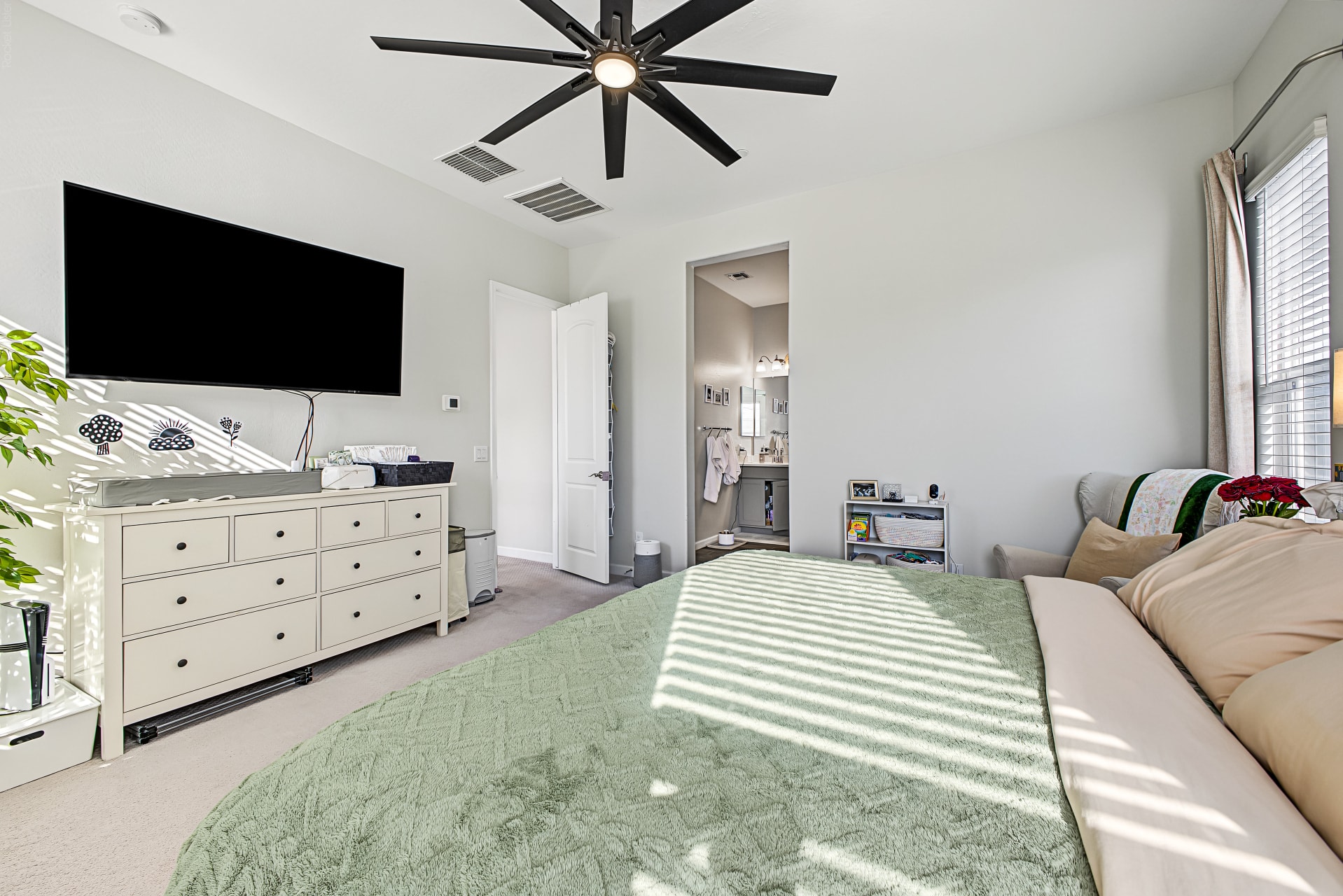 Interior — primary bedroom TV wall and dresser